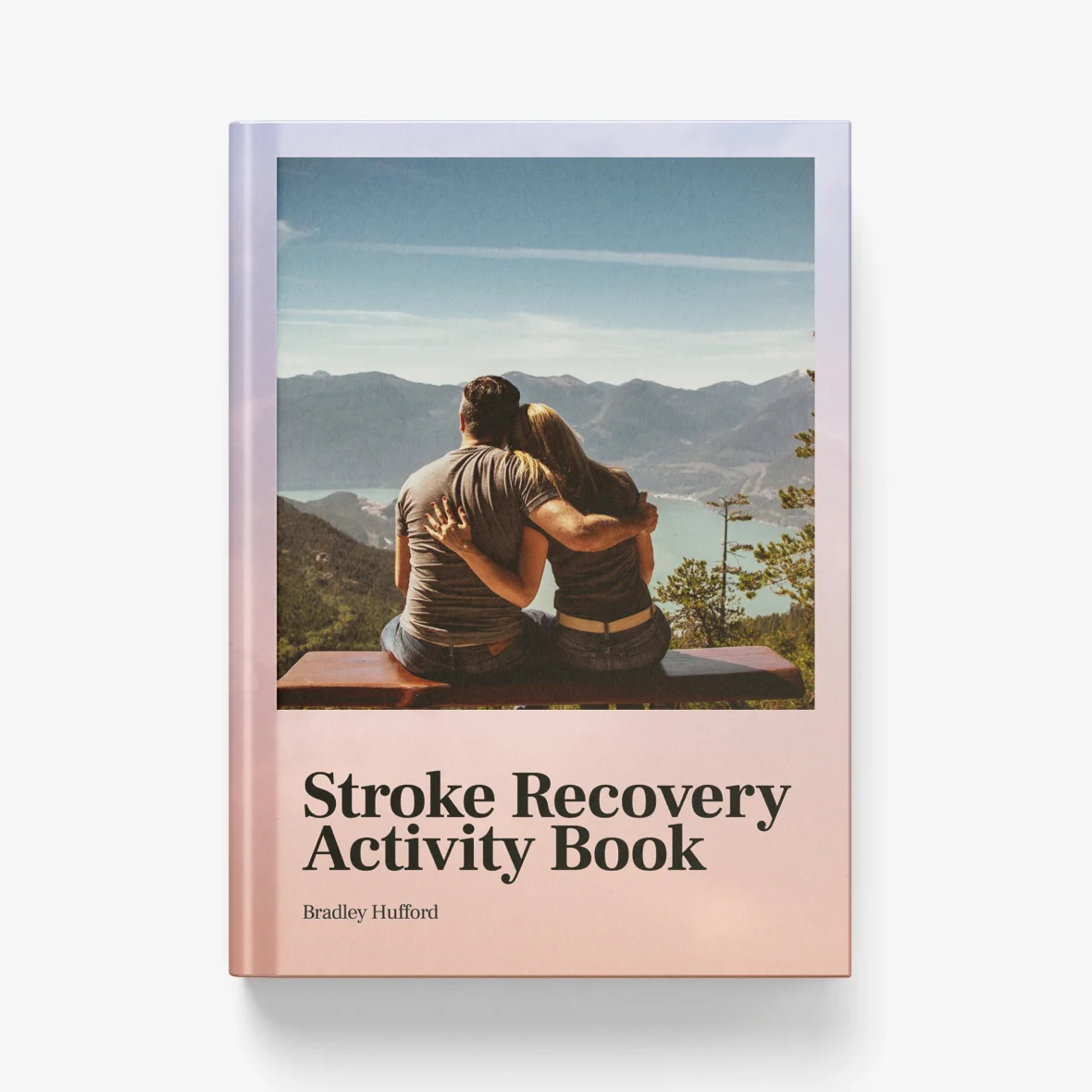 Couple sitting on a bench, back view, overlooking mountains and a lake. Stroke Recovery Activity Book cover.