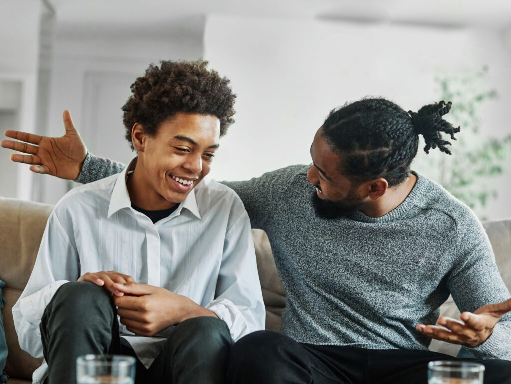 a dad laughing with his teen son
