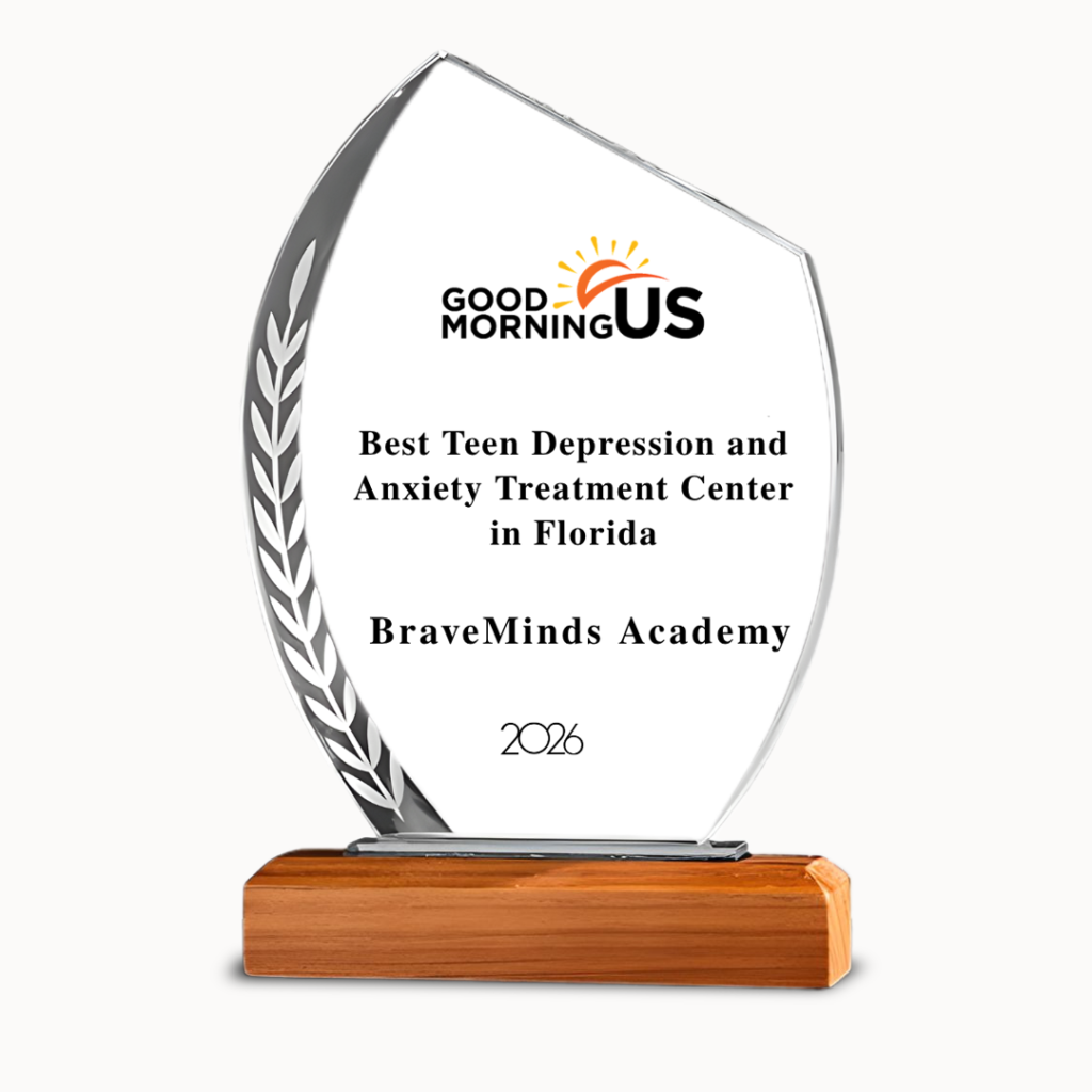 Award plaque shaped like a tear with a wooden base, displaying Good Morning US logo and text: “Best Teen Depression and Anxiety Treatment Center in Florida” and “ BraveMinds Academy,” 2026.