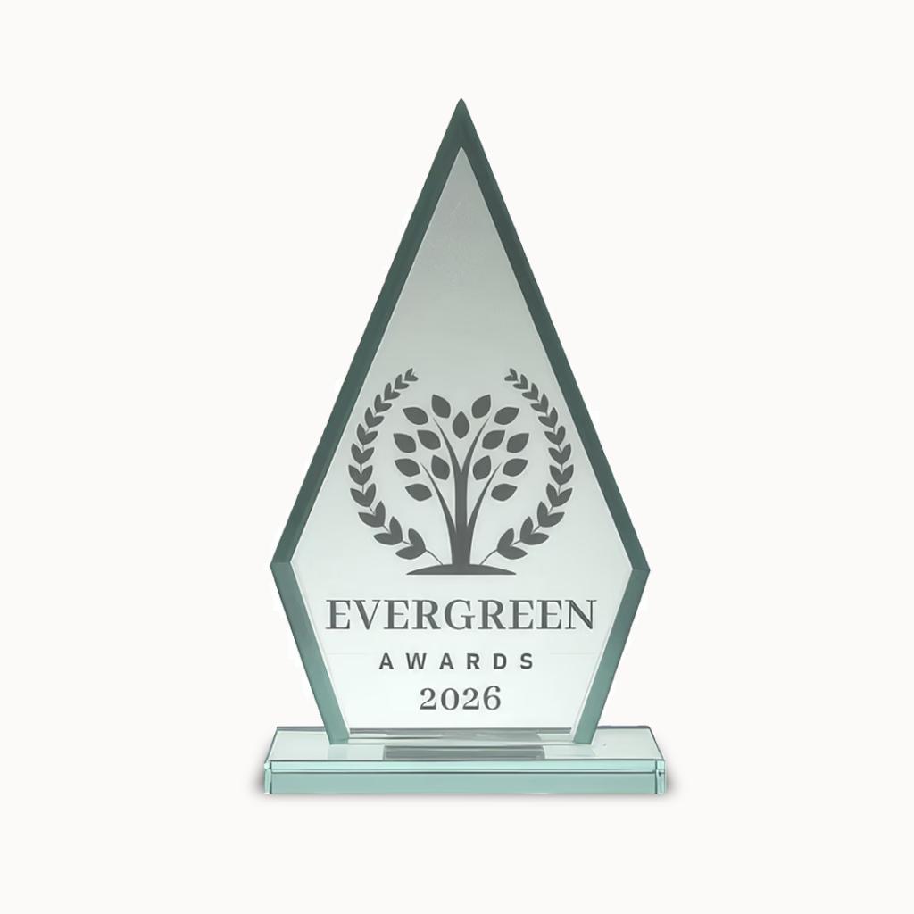 Crystal trophy with laurel wreath and tree, engraved "EVERGREEN AWARDS 2026" on front.