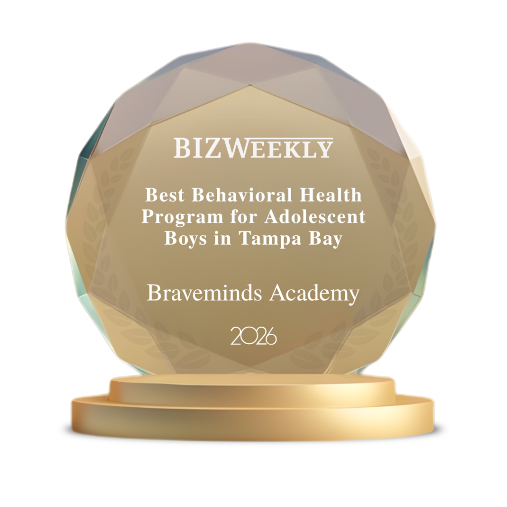 Faceted gold trophy with pedestal and engraved text about Braveminds Academy award.