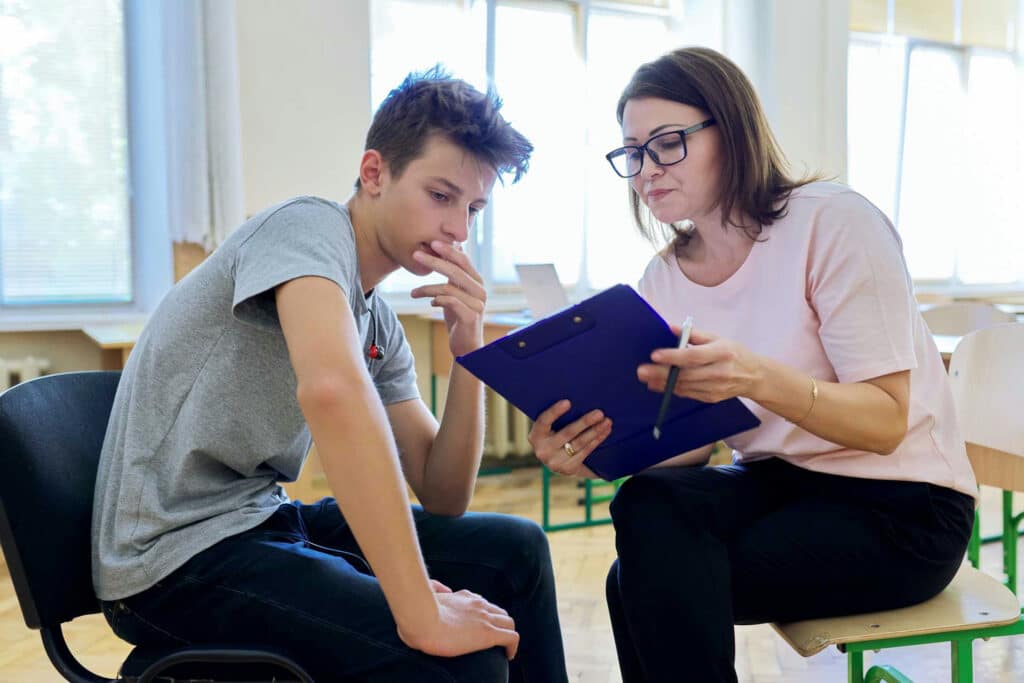 a teen boy speaking to his therapist